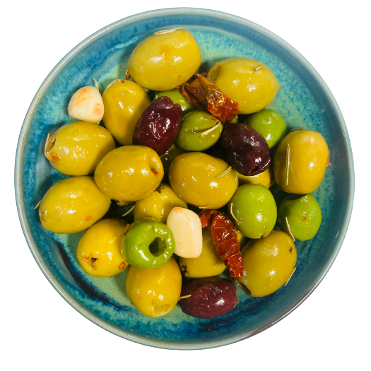 Green, kalamata and nocellara, garlic and sundried tomatoes in a bowl.